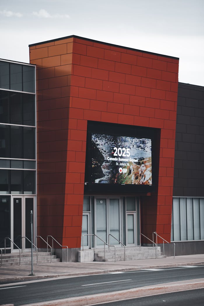 Contemporary architecture featuring a digital display for an upcoming event.